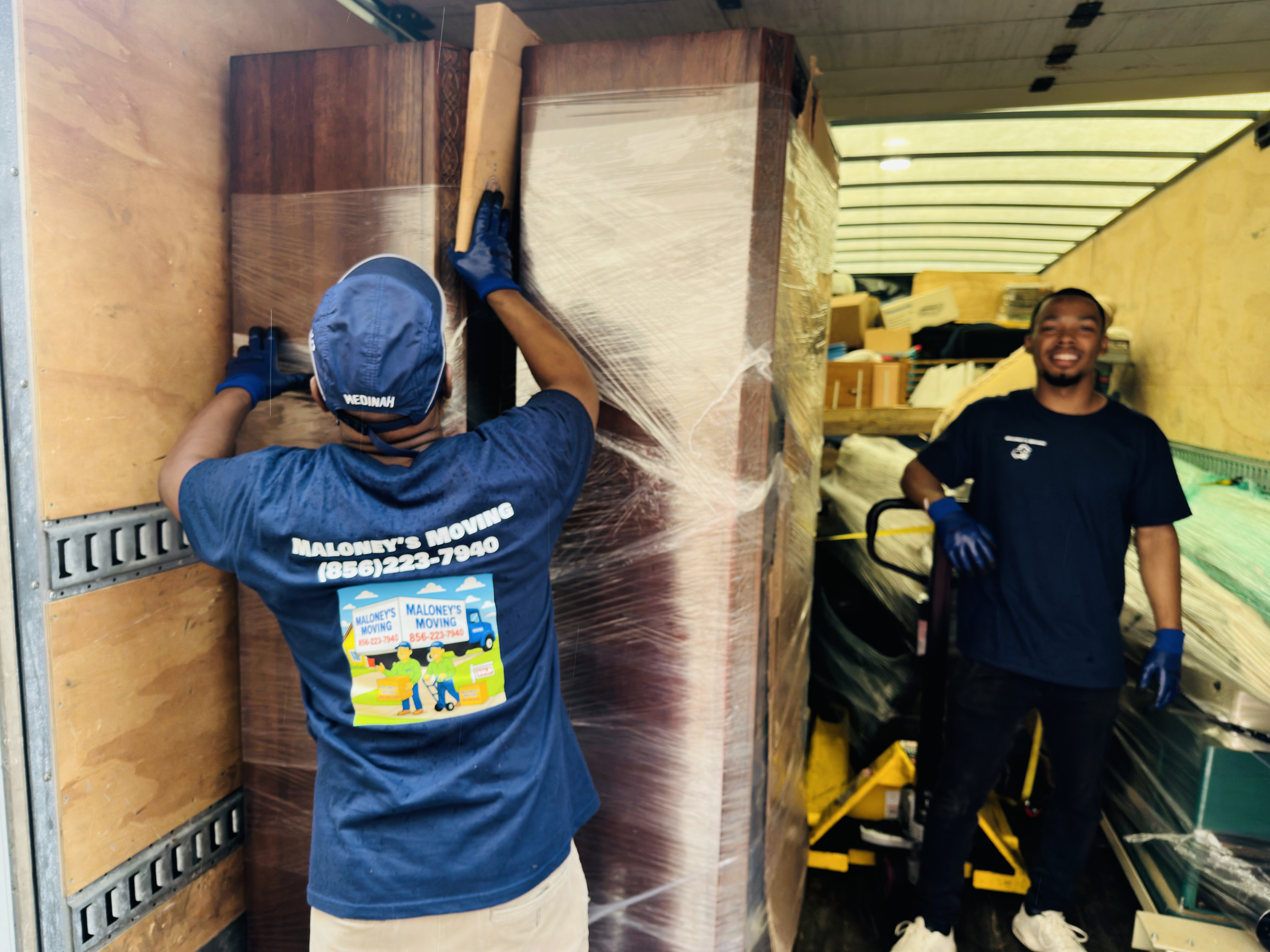 Maloney's Moving team loading truck with boxes